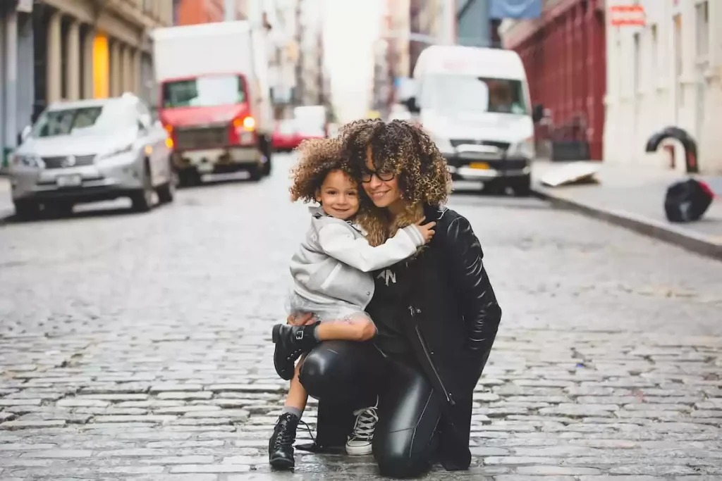 a photo of a woman smiling and holding her child